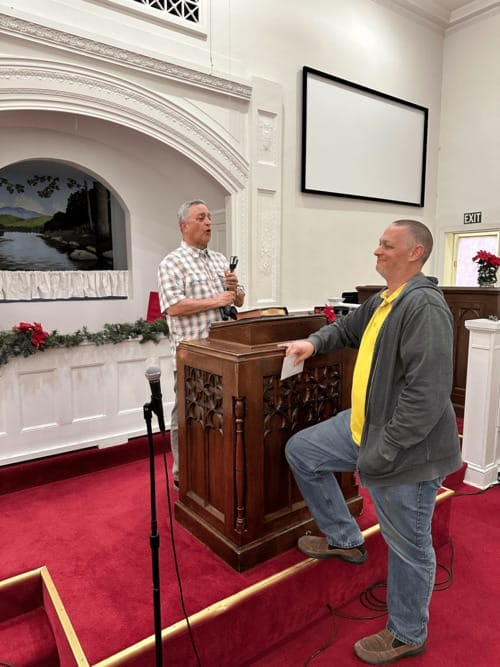 A pastor preaching from the pulpit at First Baptist Church