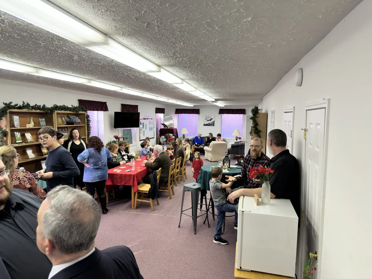 Adults and children sharing fellowship together at First Baptist Church